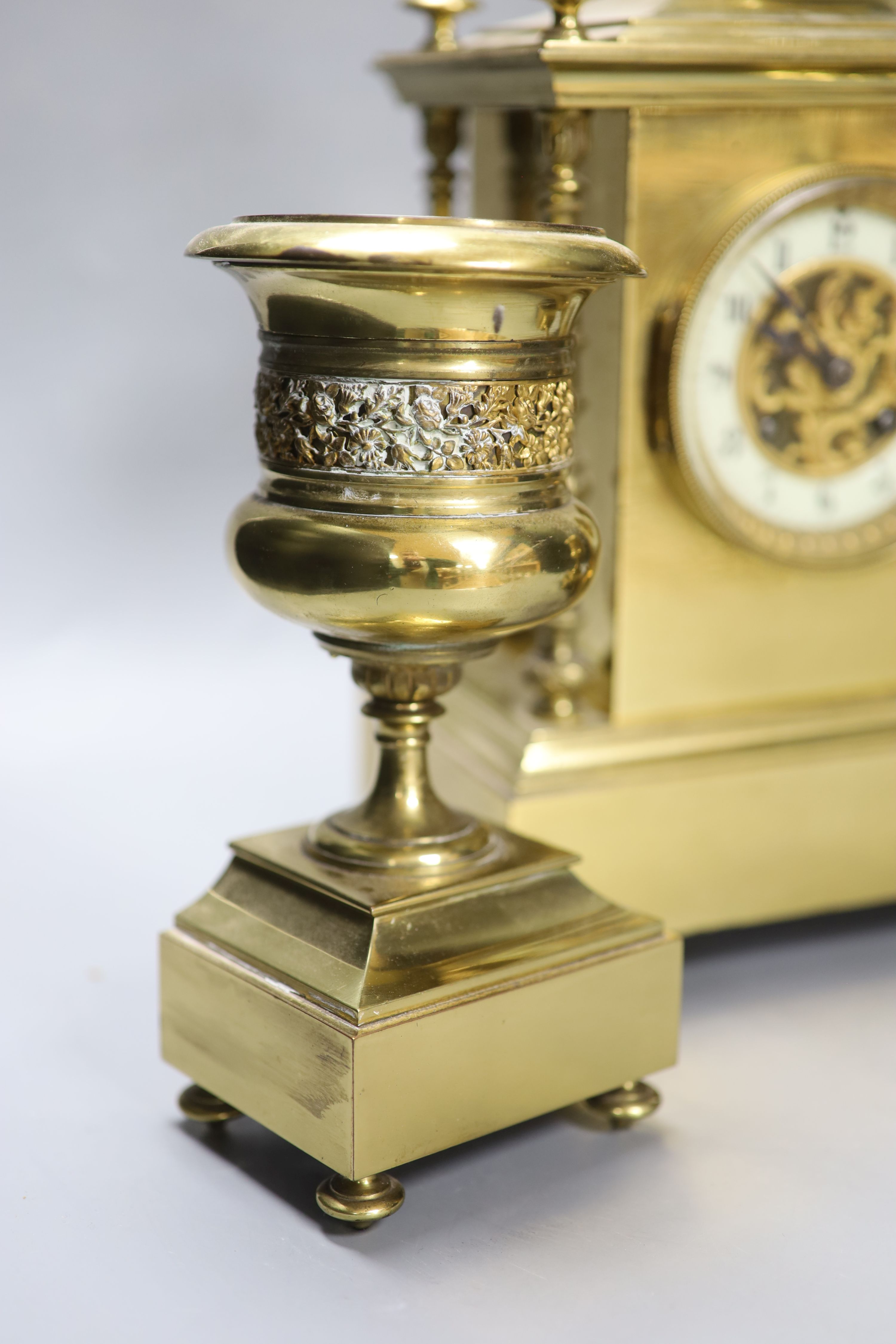 A late 19th century gilt brass three piece clock garniture, the clock with an eight day striking movement, height 39cm